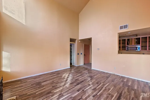 a view of a room with wooden floor