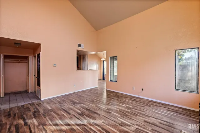 a view of a livingroom with wooden floor and window
