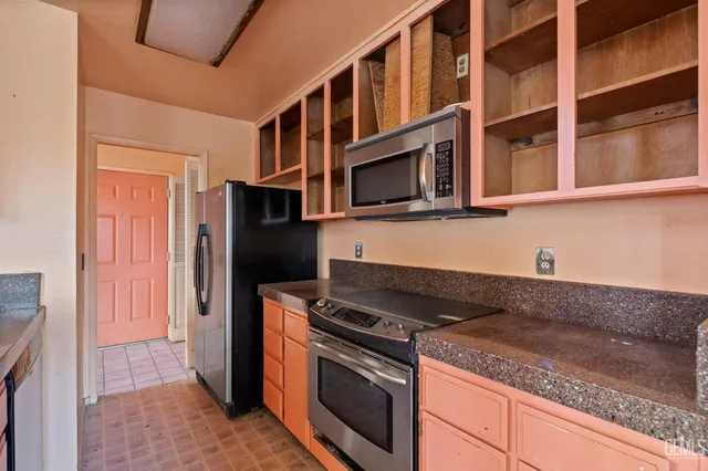 a kitchen with stainless steel appliances granite countertop a stove and a microwave