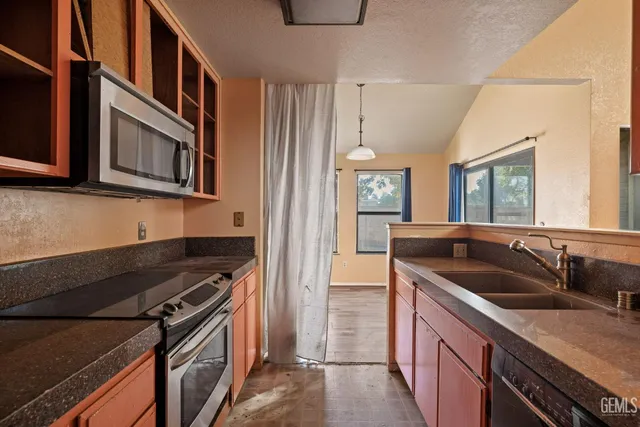 a kitchen that has a sink and a stove