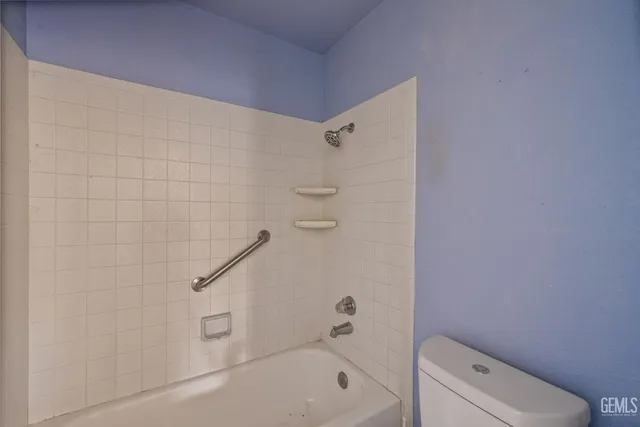a bathroom with a shower and toilet