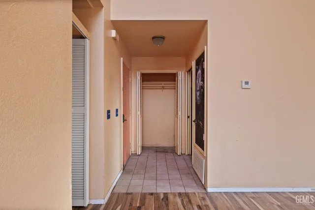 a view of a hallway with wooden floor and entryway