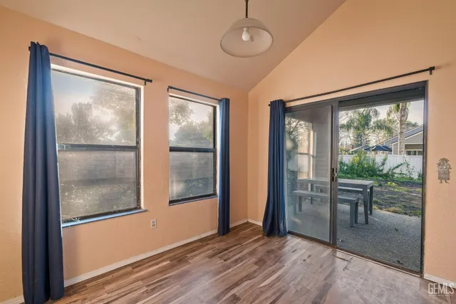 a view of a room with wooden floor and windows