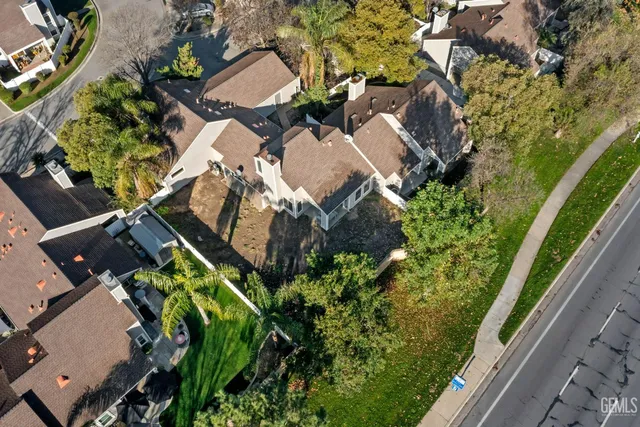 an aerial view of a house with a yard and garden
