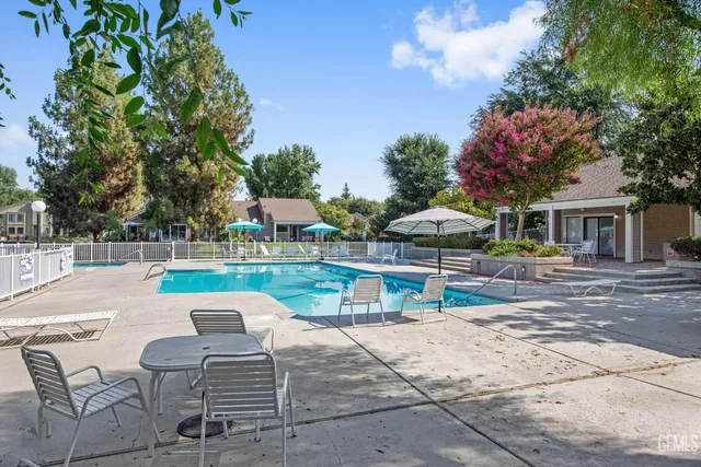 a swimming pool with outdoor seating and yard