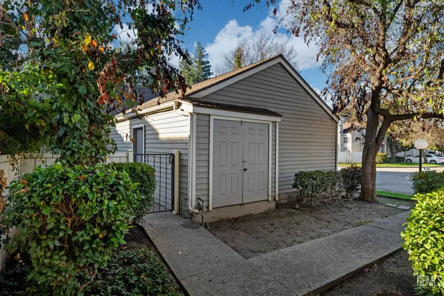 a front view of house with yard and trees around