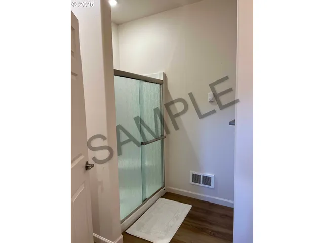 a bathroom with a granite countertop sink and a toilet