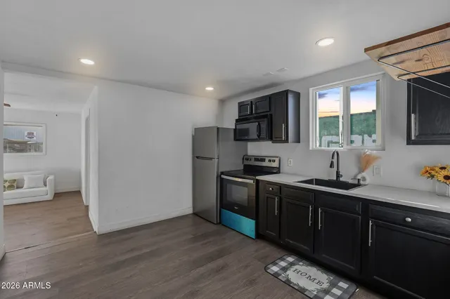 a kitchen with stainless steel appliances granite countertop a sink stove and refrigerator