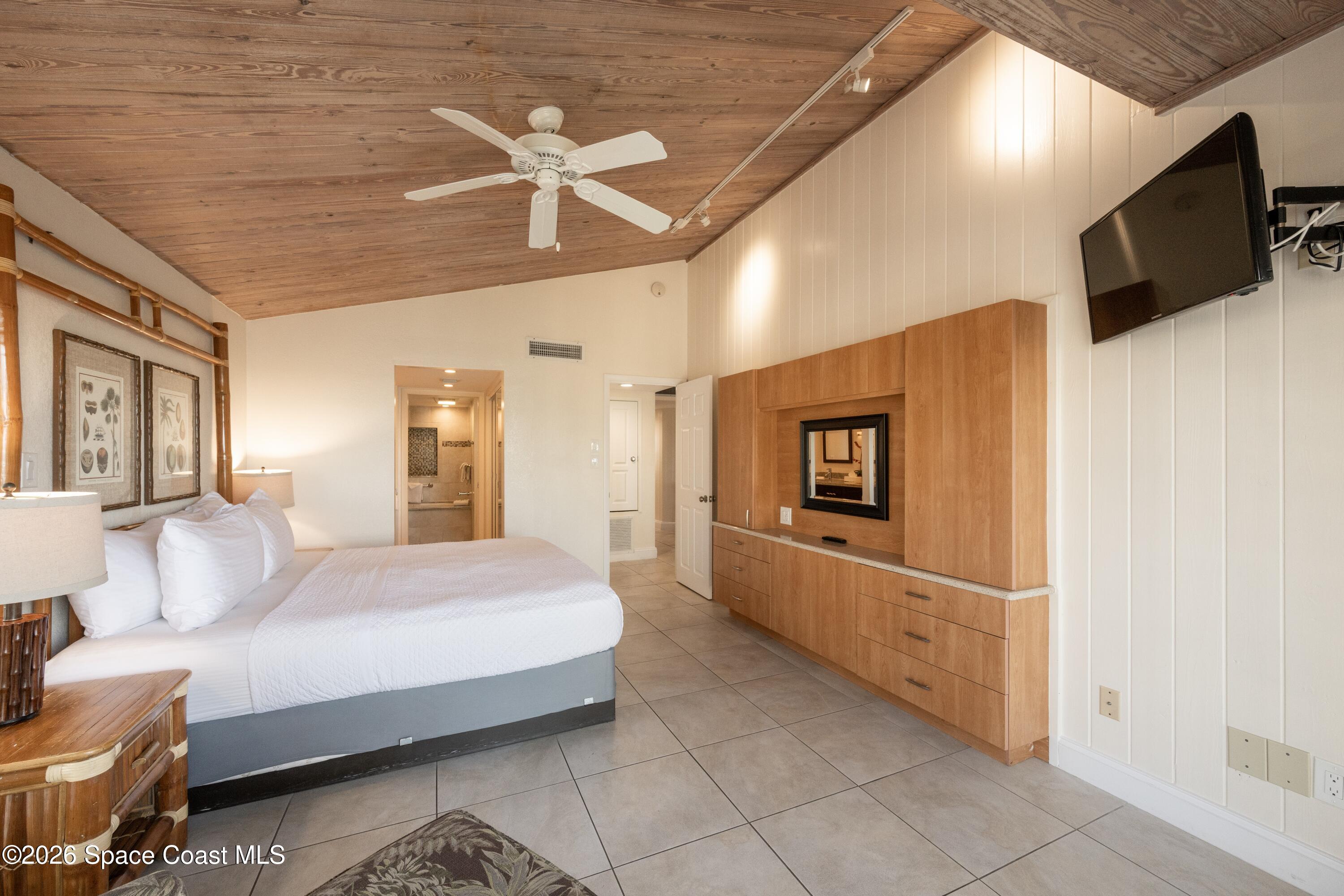 617 Front Street, Unit C54 Key West, FL 33040 - Photo 15 of 44 a spacious bedroom with a bed and a flat screen tv