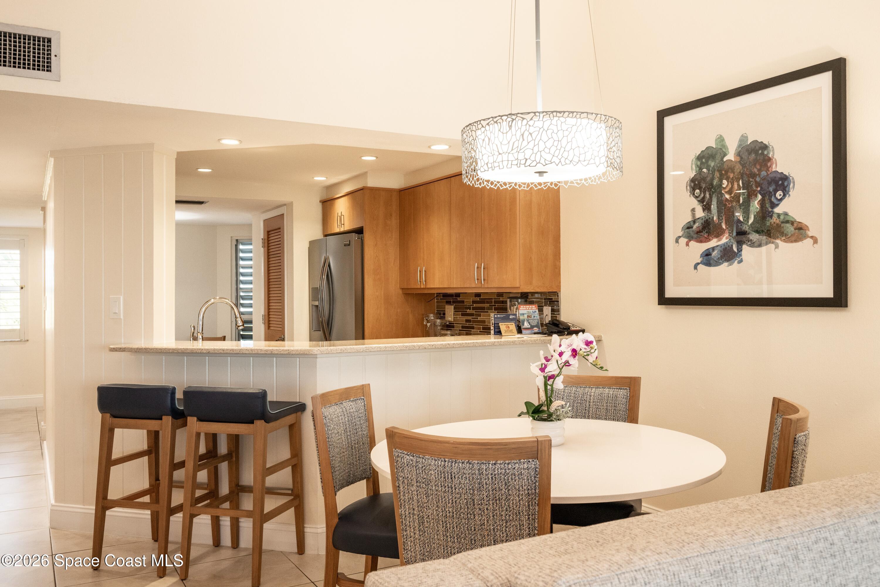 617 Front Street, Unit C54 Key West, FL 33040 - Photo 9 of 44 a view of a dining room with furniture and a chandelier