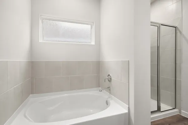 a white bath tub sitting next to a window