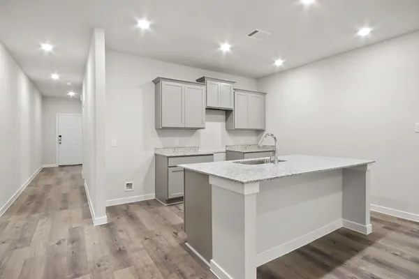 a kitchen with a sink stove and refrigerator