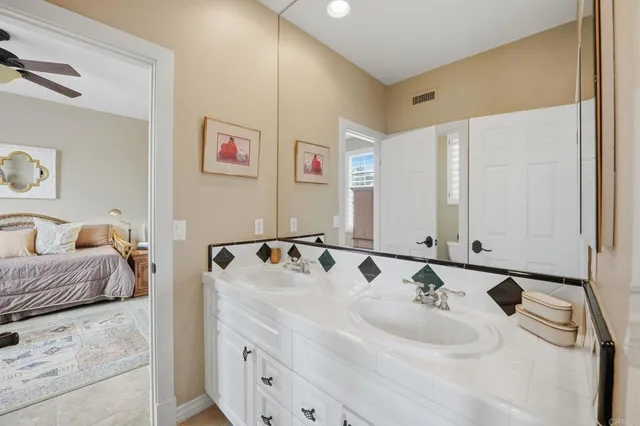 a bathroom with a tub sink and mirror