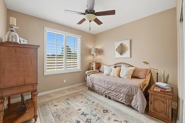 a bedroom with a large bed and a window
