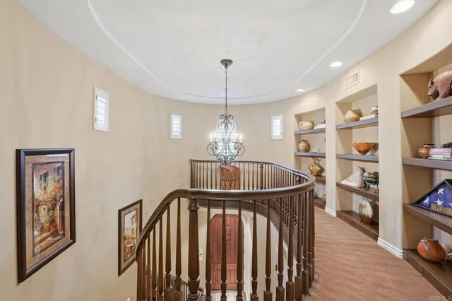 a view of a hallway with wooden floor and entryway