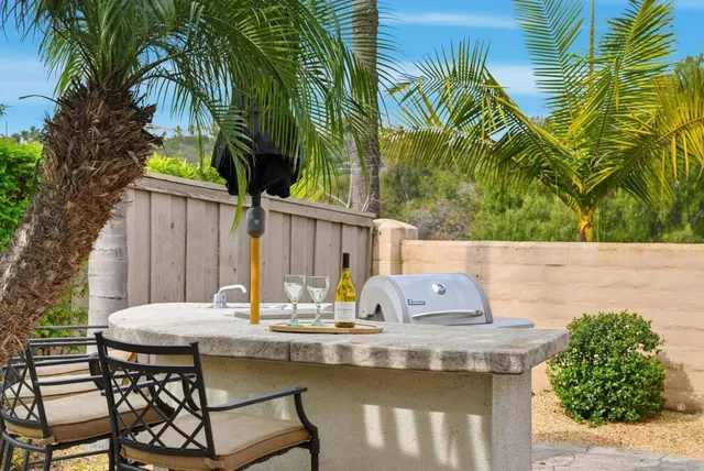a view of table and chair with potted plants
