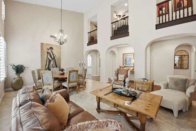 a living room with furniture chandelier and a fireplace