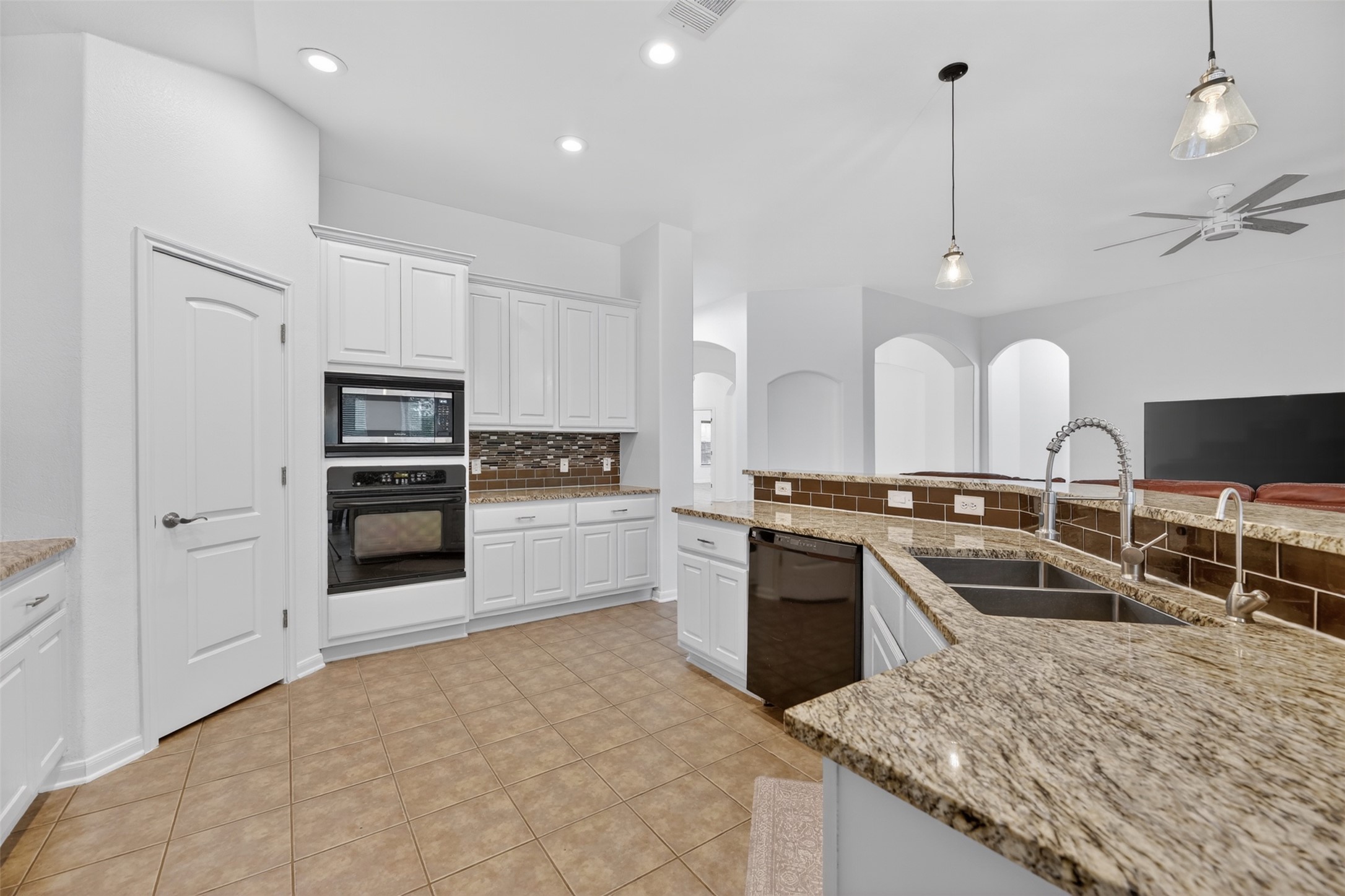 545 Manchester Lane Austin, TX 78737 - Photo 9 of 30 a large kitchen with kitchen island a sink stainless steel appliances and cabinets
