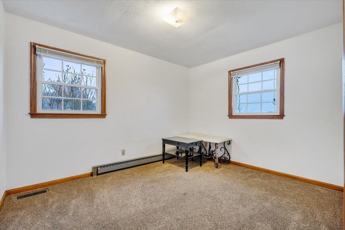 570 Scuffling Hill Road Rocky Mount, VA 24151 - Photo 21 of 35 a livingroom with lounge chair and a window