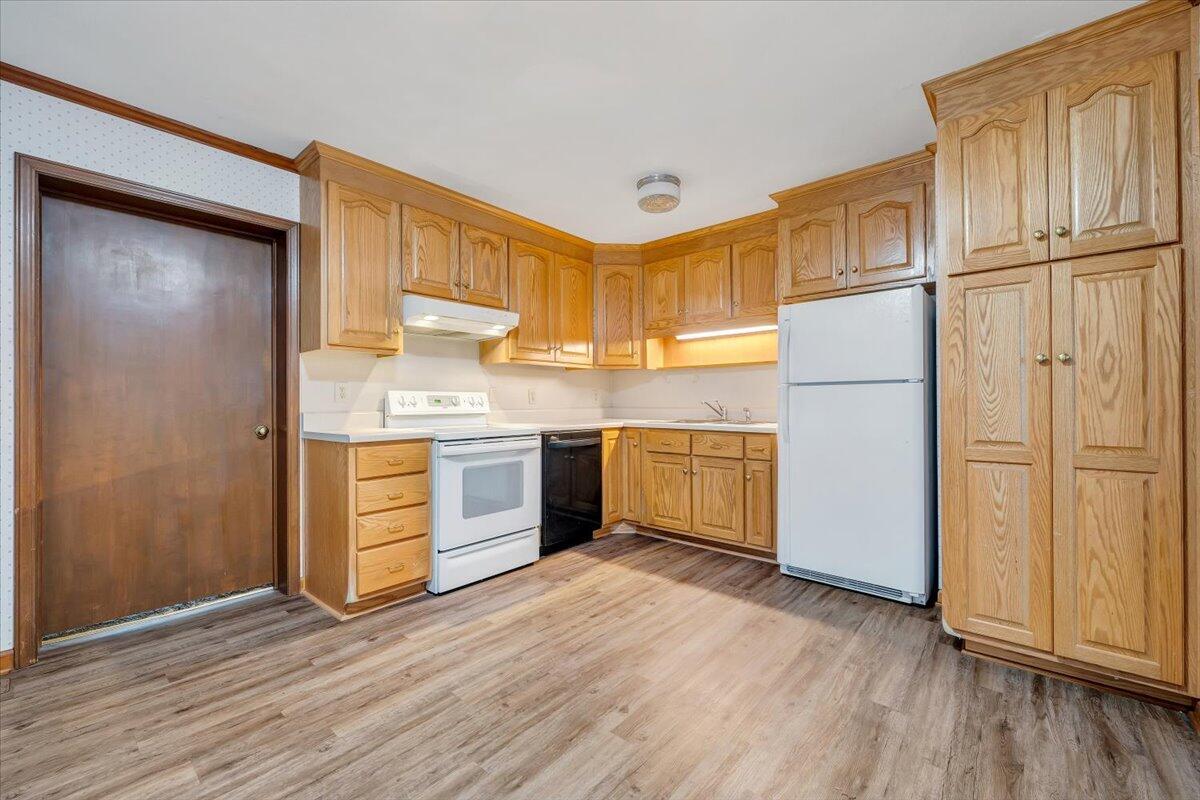 570 Scuffling Hill Road Rocky Mount, VA 24151 - Photo 10 of 35 a kitchen with stainless steel appliances a refrigerator and wooden floor