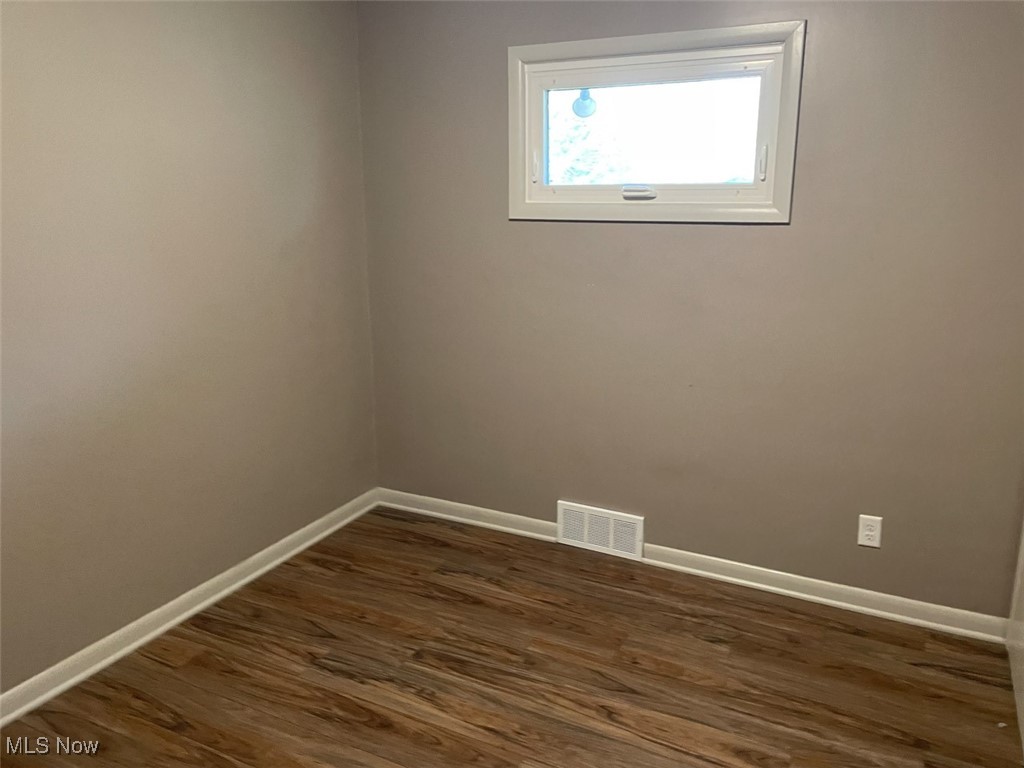 855 Georgetown Road Salem, OH 44460 - Photo 11 of 28 Empty room featuring visible vents, baseboards, and dark wood finished floors
