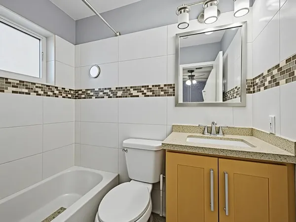 a large kitchen with stainless steel appliances kitchen island granite countertop a refrigerator a stove a sink dishwasher with a dining table and chairs