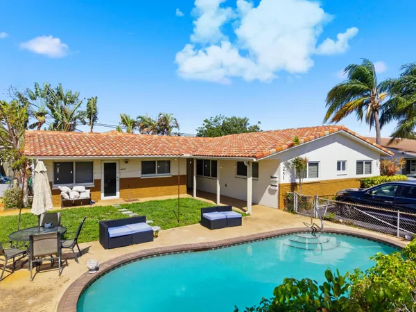 a swimming pool with outdoor seating yard and barbeque oven
