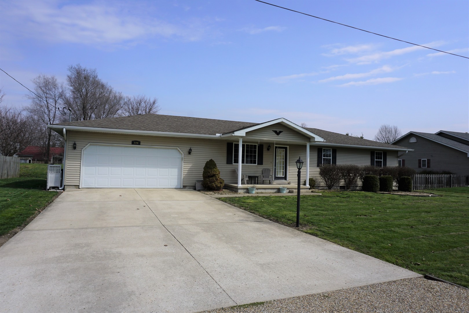 220 High Street Weldon, IL 61882 - Photo 2 of 33 a front view of a house with a yard and garage