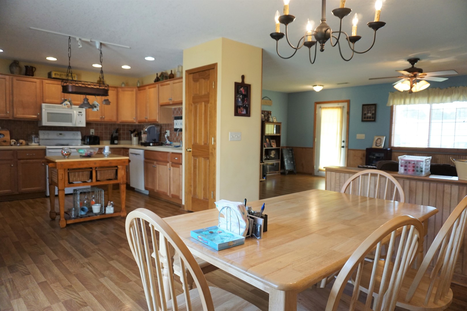 220 High Street Weldon, IL 61882 - Photo 15 of 33 a dining room with furniture a chandelier and wooden floor