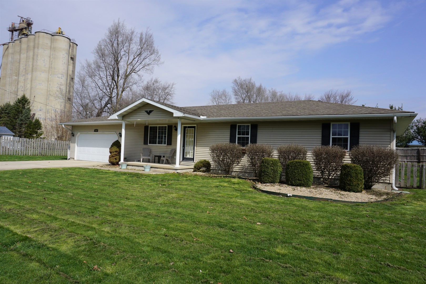 220 High Street Weldon, IL 61882 - Photo 3 of 33 a front view of a house with a garden and porch