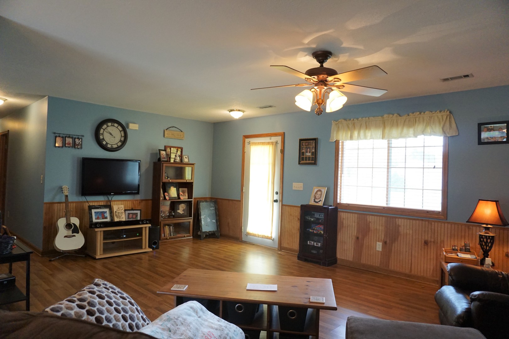 220 High Street Weldon, IL 61882 - Photo 10 of 33 a living room with furniture and a flat screen tv