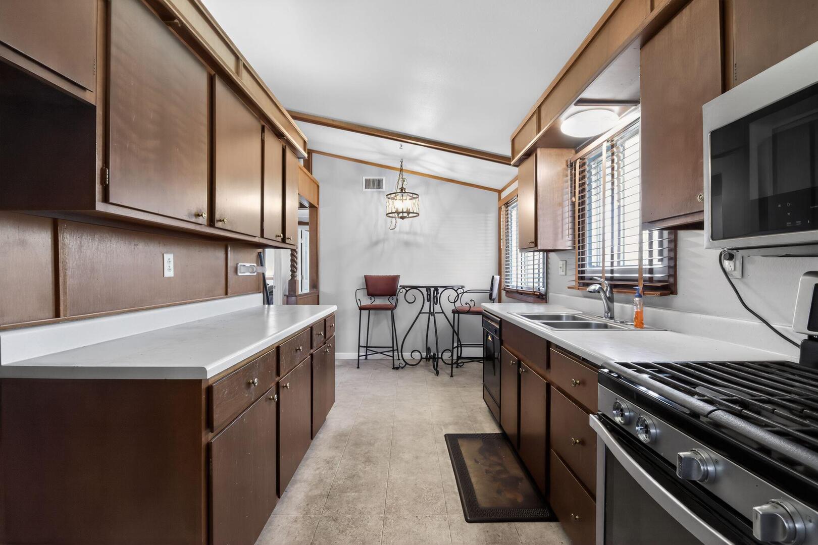 3552 North Water Street Decatur, IL 62526 - Photo 13 of 30 a kitchen with stainless steel appliances granite countertop a sink stove and refrigerator