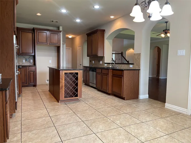 a kitchen with stainless steel appliances granite countertop a stove and a refrigerator