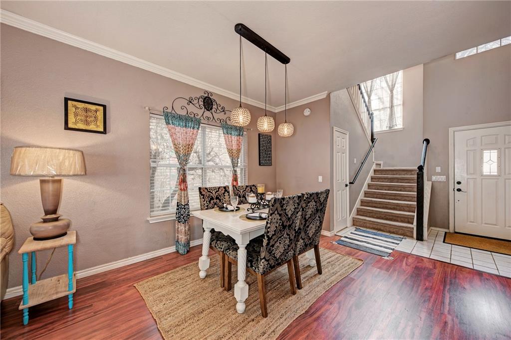 1813 White Oak Loop Round Rock, TX 78681 - Photo 5 of 30 a view of a dining room with furniture and wooden floor