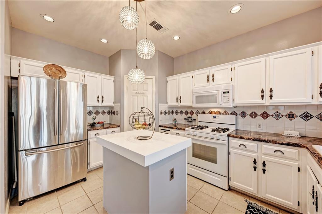 1813 White Oak Loop Round Rock, TX 78681 - Photo 9 of 30 a kitchen with white cabinets and white appliances