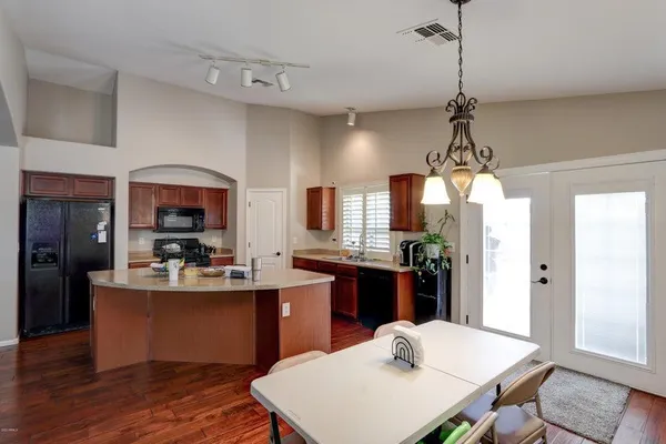 a kitchen with kitchen island a dining table and appliances