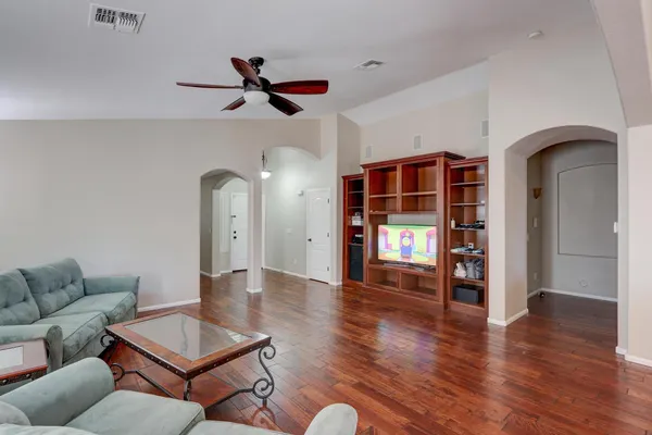 a living room with furniture and wooden floor