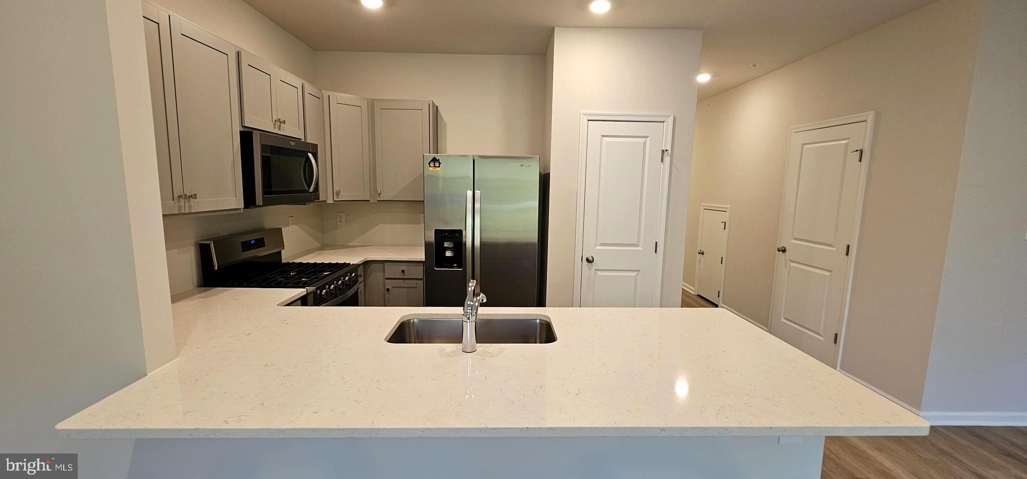 1151 Martin Road Breinigsville, PA 18031 - Photo 7 of 17 a large kitchen with a refrigerator a stove and a sink
