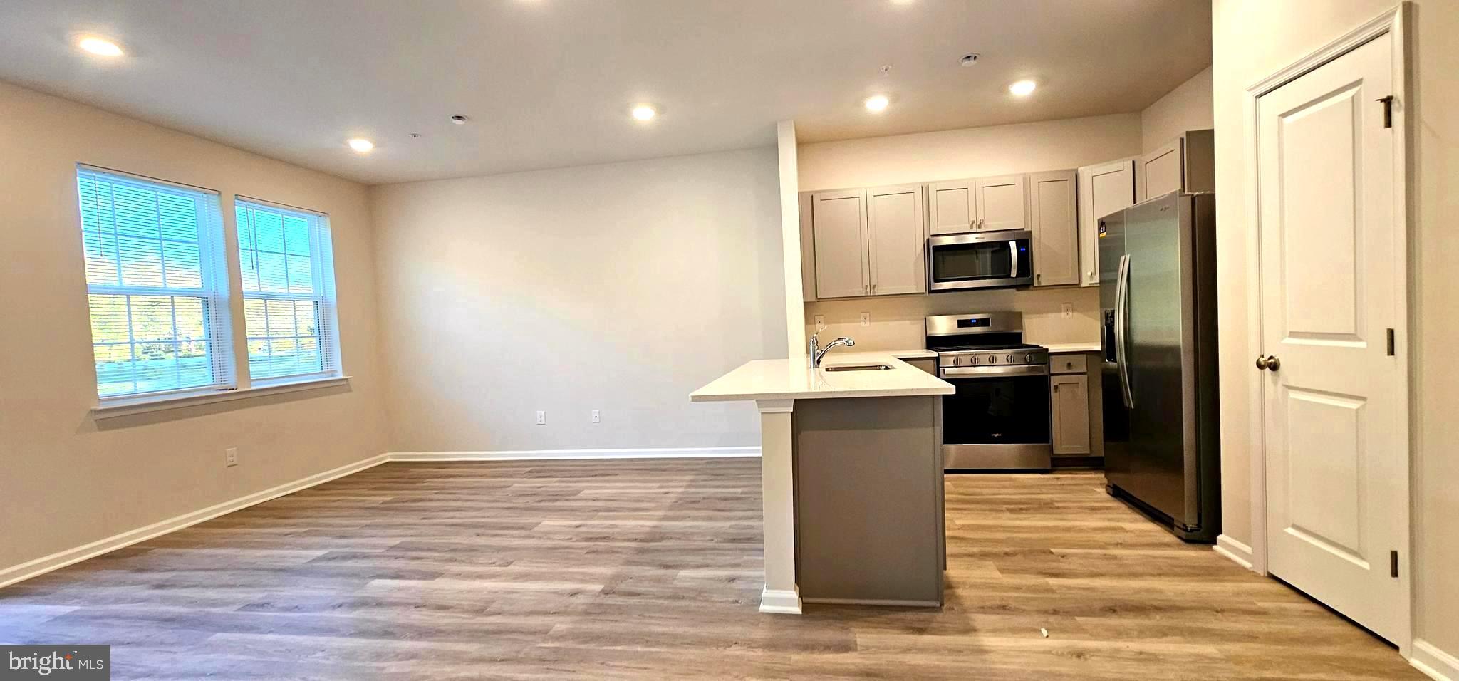 1151 Martin Road Breinigsville, PA 18031 - Photo 9 of 17 a kitchen with kitchen island a sink appliances and cabinets