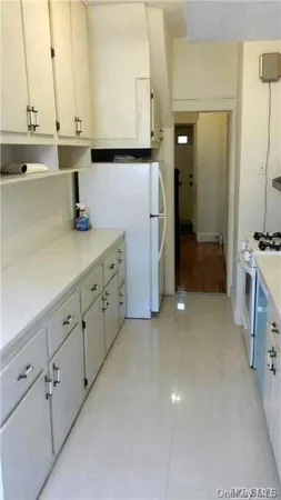 a kitchen with cabinets and a stove
