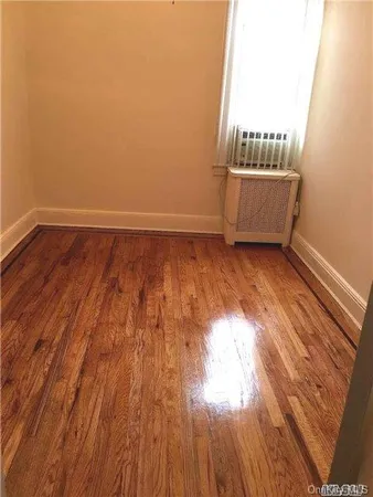 a view of an empty room and wooden floor