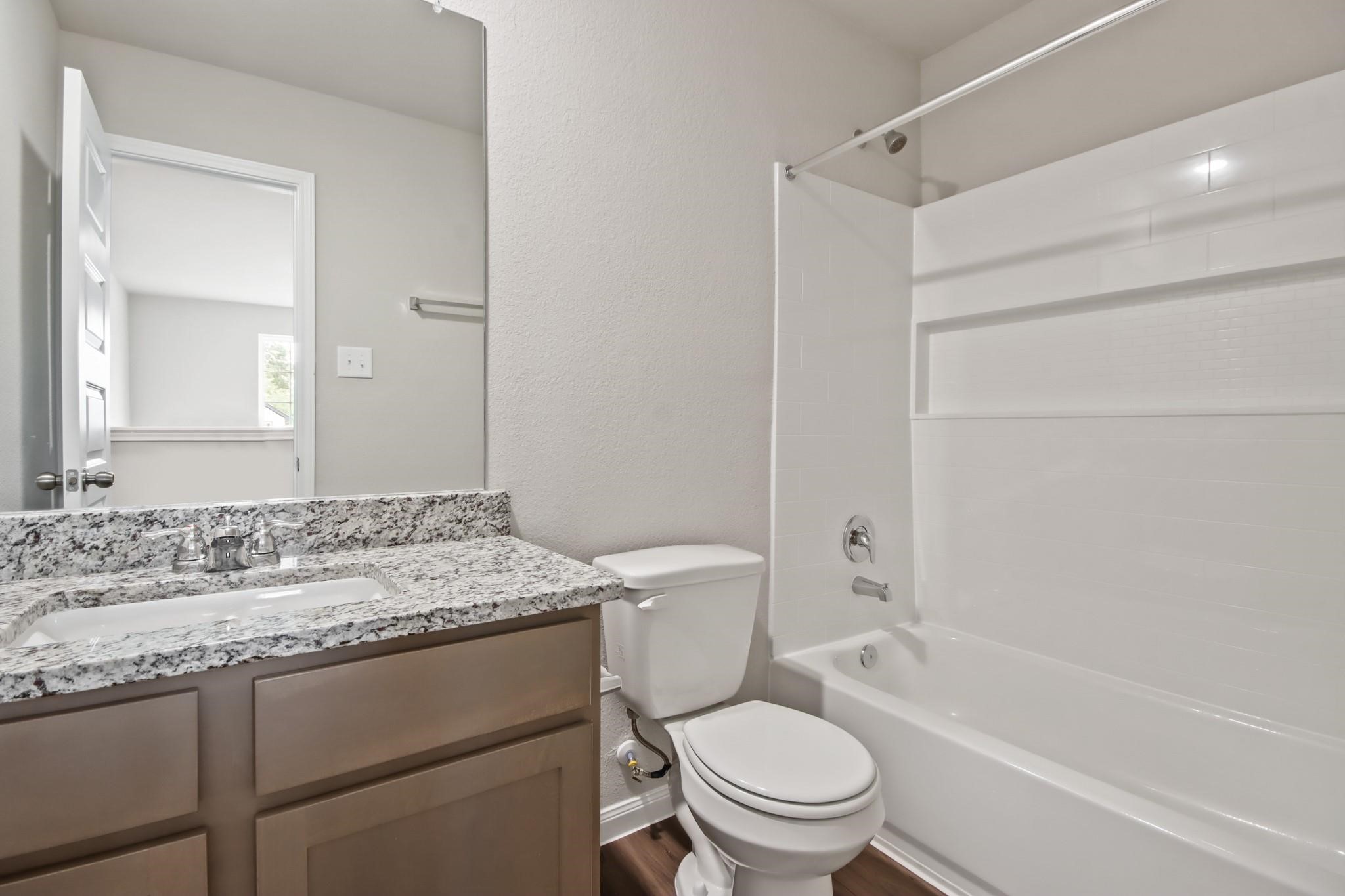 2416 Bluefish Court Conroe, TX 77384 - Photo 11 of 45 a bathroom with a granite countertop sink toilet and shower