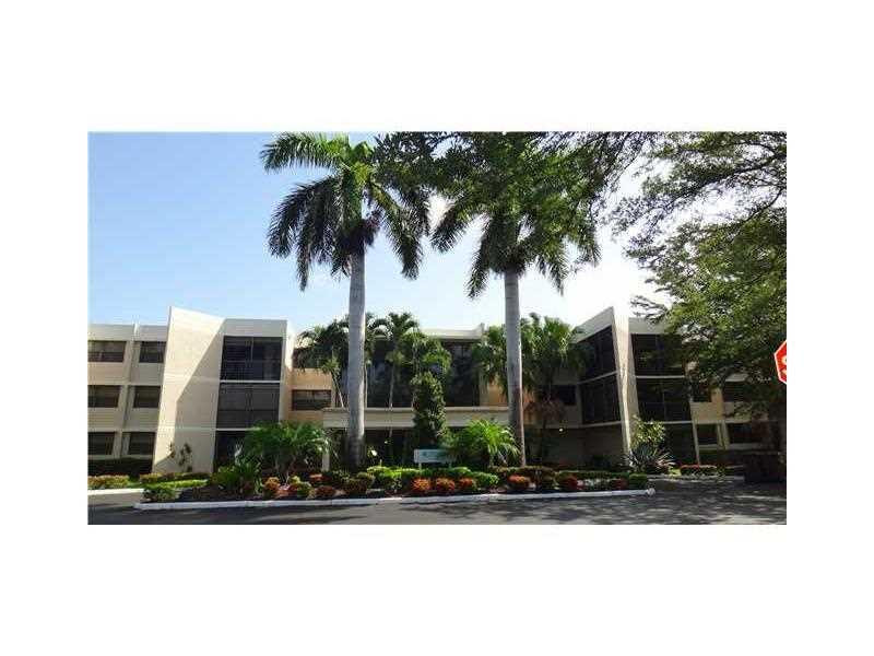 16251 Golf Club Road, Unit 210 Weston, FL 33326 - Photo 1 of 28 a front view of a house with garden