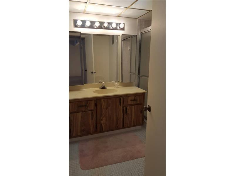 16251 Golf Club Road, Unit 210 Weston, FL 33326 - Photo 11 of 28 a bathroom with a sink and a mirror
