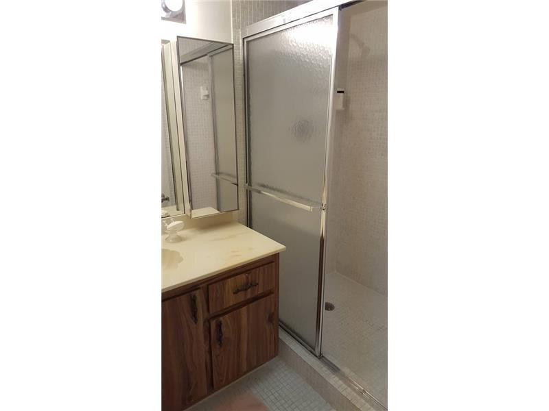 16251 Golf Club Road, Unit 210 Weston, FL 33326 - Photo 12 of 28 a bathroom with a sink and a mirror