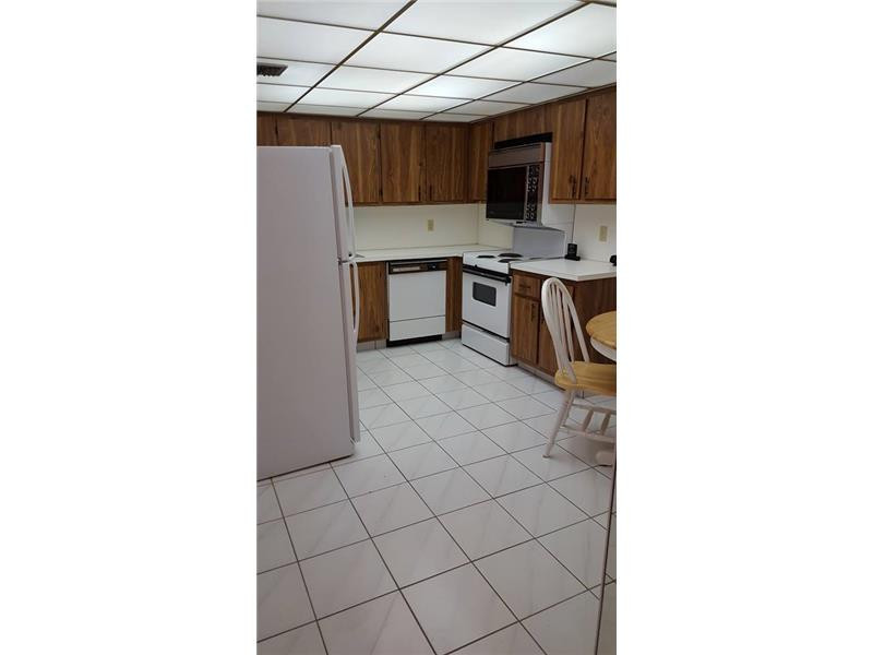16251 Golf Club Road, Unit 210 Weston, FL 33326 - Photo 13 of 28 a kitchen with stainless steel appliances a stove and cabinets