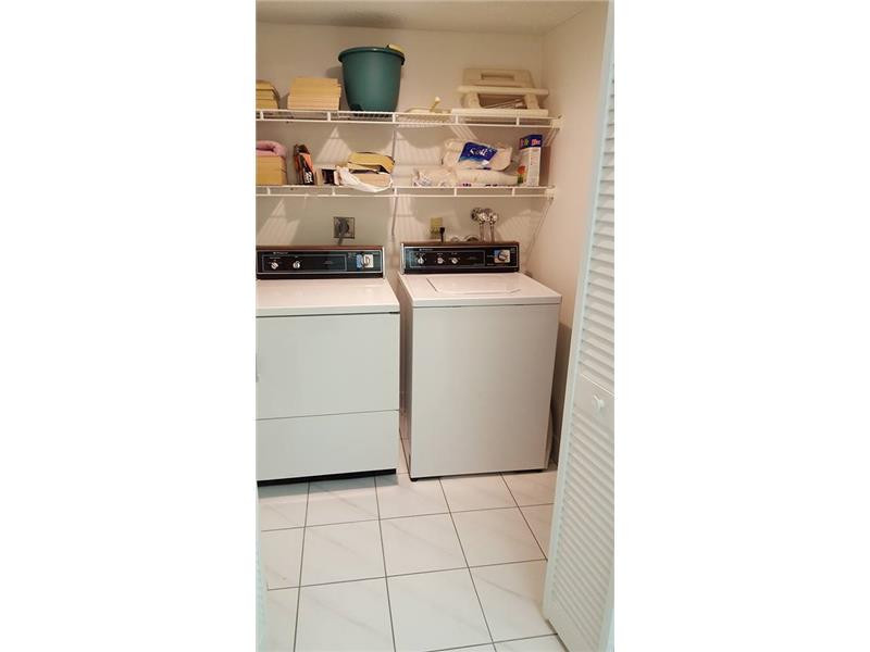 16251 Golf Club Road, Unit 210 Weston, FL 33326 - Photo 16 of 28 a kitchen with a sink and cabinets