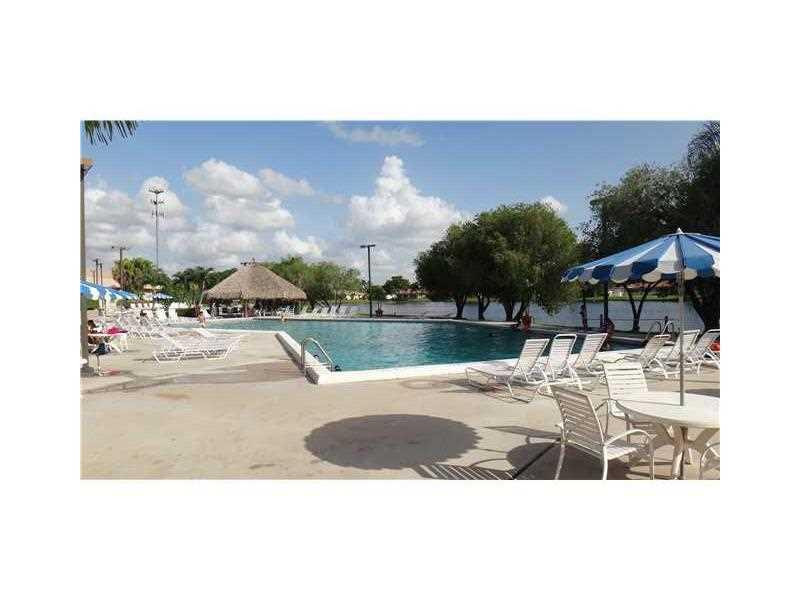 16251 Golf Club Road, Unit 210 Weston, FL 33326 - Photo 19 of 28 a view of a swimming pool and lounge chair