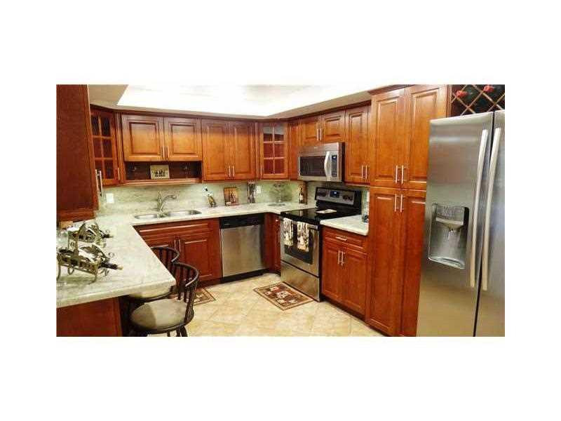 16251 Golf Club Road, Unit 210 Weston, FL 33326 - Photo 23 of 28 a kitchen with stainless steel appliances granite countertop a refrigerator a stove and a sink