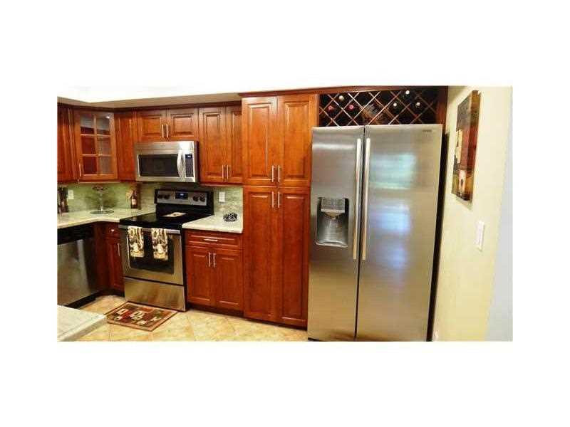 16251 Golf Club Road, Unit 210 Weston, FL 33326 - Photo 24 of 28 a kitchen with stainless steel appliances granite countertop a refrigerator and a sink